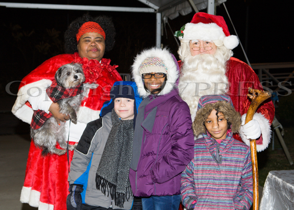 Aquanetta “FerryGodmother” Wright and Santa Claus pose with Sam Cerone, Skye Davis and Ammarah Royster as carolers sang on the Newburgh waterfront to the ferry riders as they disembarked on Thursday, December 18, 2014. Hudson Valley Press/CHUCK STEWART, JR.