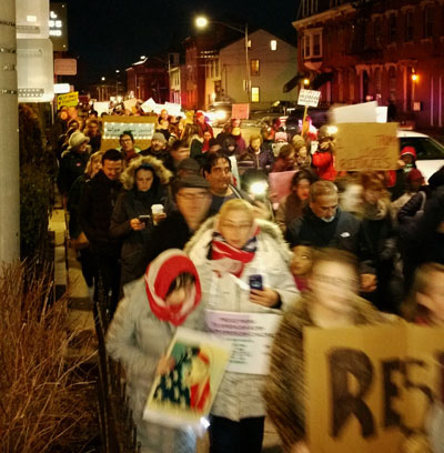 Hundreds of protesters gathered late Wednesday afternoon in Poughkeepsie to show their displeasure with President Trump’s recent travel ban and his plan to build a wall on the Mexico border.