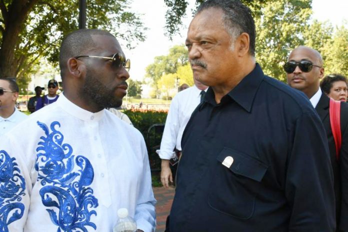 Rev. Jamal-Harrison Bryant and the Rev. Jesse Jackson Sr. chat on the sideline during the rally. Photo: Roy Lewis/Trice Edney News Wire