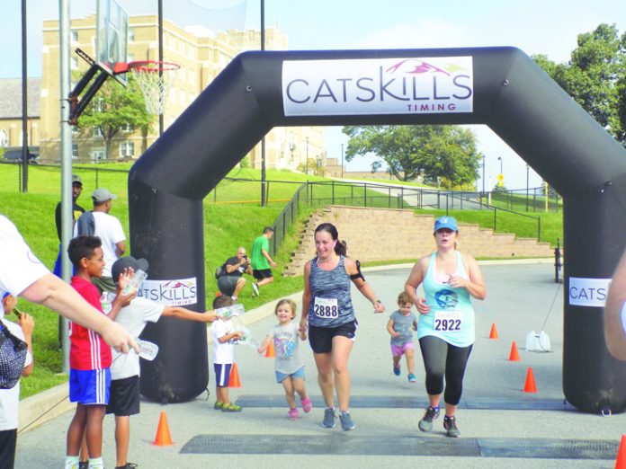 Runners cross a checkpoint during the Bishop Dunn Memorial School’s Cupcake 5K Run/Walk on Sunday, September 16.
