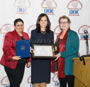 Sonia Ayala, left, and Mary Olivera, right, present Jennifer Echevarria, center, with the Leadership Award during the Latino Democratic Committee of Orange County Fifteenth Annual Fall Dinner Dance at Cafe Internationale in Newburgh, NY on Saturday, October 13, 2018. Hudson Valley Press/CHUCK STEWART, JR.