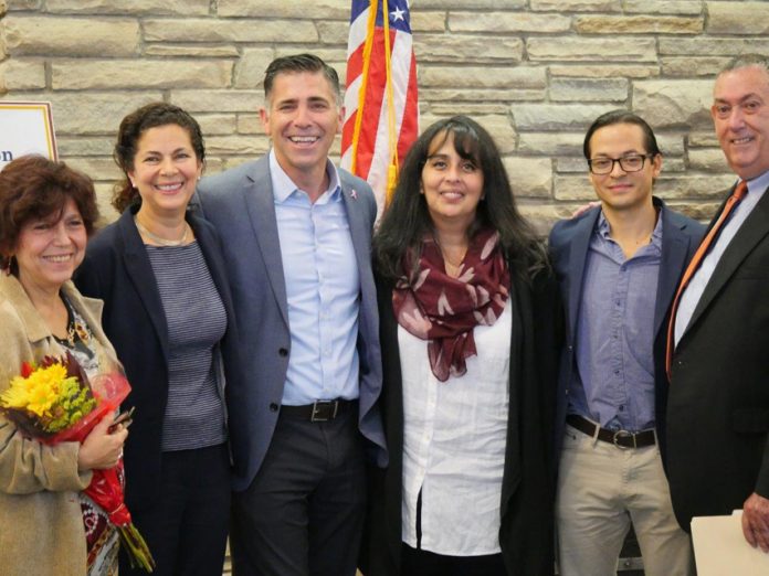 Pictured from left to right: Dolores Quiles, ESL Professor at SUNY Ulster; Alexandra Baer, Director of Unison Arts Center; Ulster County Executive Mike Hein; Maria Elena Ferrer-Harrington, Director of Community Engagement at Health Alliance; Noe Del Cid, Owner of Peace Nation Café; and Arnaldo Sehwerert, Regional Director of Mid-Hudson Small Business Development Center.