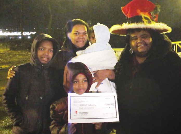 Aquanetta Wright (far right) poses with Tiara Fox (back left) and her three boys after being recognized as one of the recipients of a gift from the “Family-n-Need Christmas Give-away” contest. Photo: Ramona Torres
