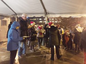 Ferry Godmother’s 13th Annual Christmas Caroling event was held last Thursday.  An array of joyous community member carolers congregated, while singing a medley of popular Christmas songs to ferry boat commuters, as they returned home after their long work day. Photo: Linda Jansen