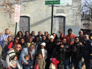 The Life Restoration Church family posed for a photo in front of the new street signed named after their pastor RD McLymore.