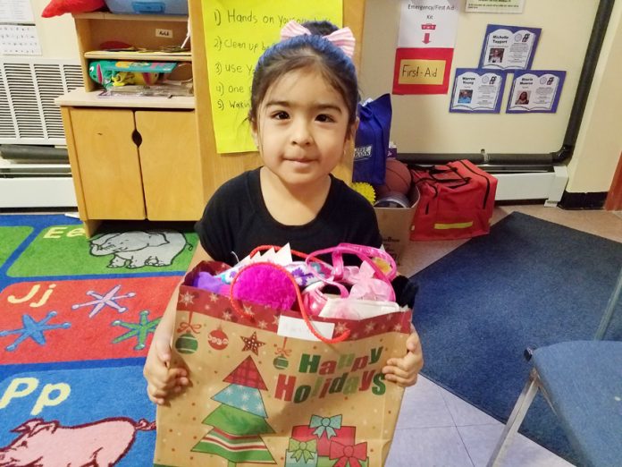 Head Start student Amaia Mendez, 3, of Middletown with her gift bag at Head Start in Scotchtown.