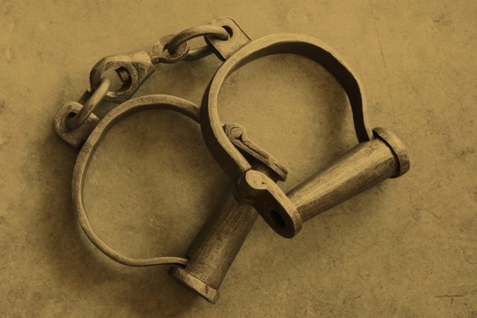 Harsh stark reality of slavery implied by simple monotone composition of ankle shackles worn by slaves in the early 1800s. Photo: Charles Schug