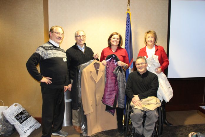 Catholic Charities of Orange, Sullivan, and Ulster was the beneficiary of a winter coat drive hosted by the Newburgh Rotary Club. The donation of coats was presented to Catholic Charities CEO Dr. Dean Scher, center left, and Kristin Jensen, Chief Advancement Officer, center right, at a recent Club meeting by members Doug Sturomski, left, Deb Sager, Rotary Club President, right, and Doug Hovey, front.