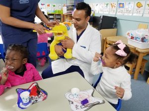 SUNY Orange Dental Hygiene student Nicholas Mahabir oversees teeth brushing which is part of the school day at Head Start in Middletown. 