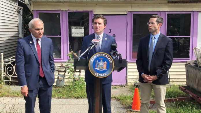Senator James Skoufis (D-Hudson Valley) at podium and Assemblyman Ken Zebrowski (D-Rockland), right, announced Monday that their legislation to require disclosure of residential properties owned by limited liability companies (LLCs) was signed into law by the Governor. Under the new law, anonymous LLCs will now be required to share the names and contact information for all owners, managers, and agents associated with the company at the time of a real estate transaction. NYS Assemblyman Jonathan Jacobson, left.