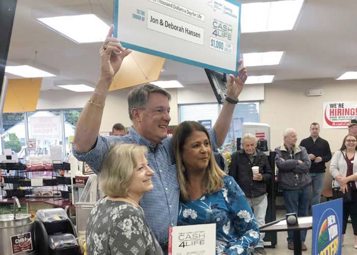 Jon and Deborah Hansen celebrate their big win on Wednesday with the Lottery’s Yolanda Vega.