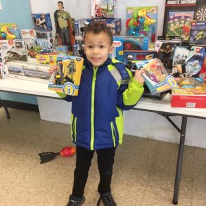 Four year old Xavier Shields from the City of Beacon shows some of the toys he selected from Saturday’s Prince Hall Hebron Lodge’s 15th Annual Holiday Party. In addition to the large toy giveaway, the three hour event included grab bag treat packages, holiday music and plenty of cheer.