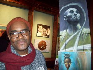 Artist Jean Benoit stands by one of his depictions of NBA legend Kobe Bryant. The piece is one of 55 presently on exhibit at the Howland Cultural Center as part of the 26th Annual Celebration of National African-American History Month, featuring African-American Artists of the Hudson Valley.