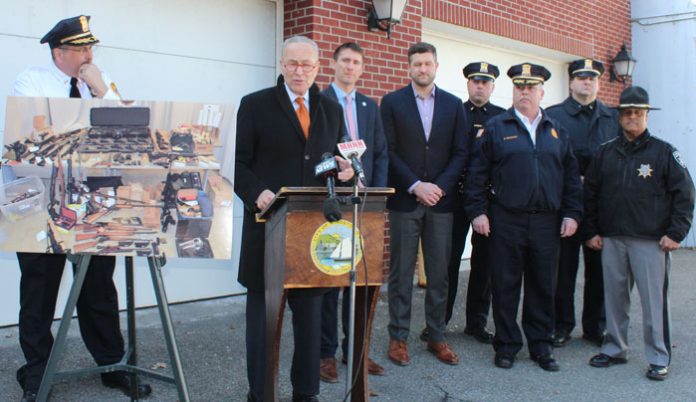 Center Charles Schumer, at the podium, is surrounded by law enforcement and county officials in KIngston.