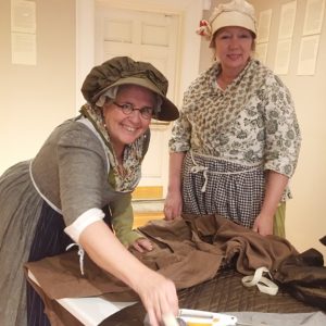 From left are Robin Stiles and Laurie Whitney of the 4th Connecticut Regiment, a popular living history group, which recreates Revolutionary War battles- life all over the East Coast. Here, they are are making clothes from scratch, one of many activities offered at the well-attended three day Washington Headquarters George Washington Birthday Celebration.
