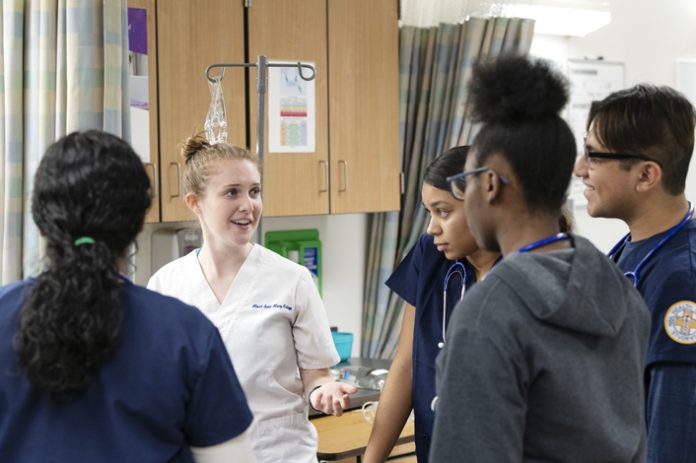 Recent Mount Saint Mary College Nursing graduate Shannon Christiano of Yaphank, N.Y. (center) earned the AMA NY Future Nurse Leader Award at a recent virtual celebration. Christiano, president of the Mount’s Student Nurses’ Association, is seen here mentoring students from Newburgh Free Academy via the PALS program in November of 2019. Photo: Lee Ferris.