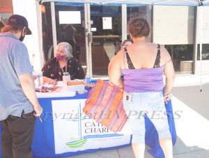 On Thursday, August 20, Regina Cieslak of Catholic Charities of Orange, Sullivan and Ulster provides information on Narcan training during a pop-up food distribution event in Newburgh, NY. HUDSON VALLEY PRESS/ Chuck Stewart, Jr.