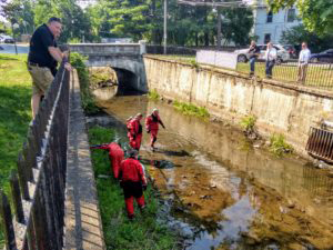 A 16-year-old boy has been charged as an adolescent offender for committed attempt assault for firing a gun at a vehicle near 29 North Hamilton Street in the City of Poughkeepsie late Friday morning, August 7. Pictured above divers searching the Fallkill Creek for weapons.
