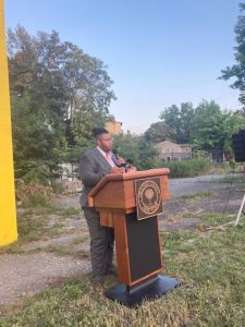 Artist Vernon Byron, whose mural of Frederick Douglass was unveiled at Tuesday’s 150th Anniversary event of the historic icon discusses his piece with those in attendance, near the symbolic spot where Douglass once spoke about voting rights for all.