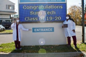 Surgical technology graduates Courtney Balding, (Left) of Milton and Khari Wellman, (Right) of Poughkeepsie, pose happily in front of the Ulster BOCES Adult Career Center on Saturday, November 7.