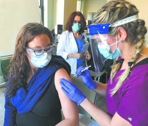 Mount Nursing student Alexana Gadaleto of New Paltz, N.Y. administers a COVID-19 vaccination to Dr. Valerie C. Cluzet, an infectious disease specialist.