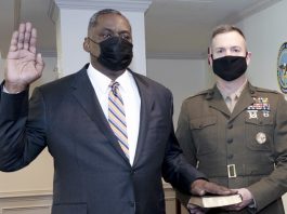 Retired Army Gen. Lloyd J. Austin III is sworn in as secretary of defense, the Pentagon, Washington, D.C., Jan. 22, 2021. Holding the Bible is the Junior Military Assistant to the Secretary of Defense Marine Corps Lt. Col. Caleb Hyatt. Photo: Lisa Ferdinando