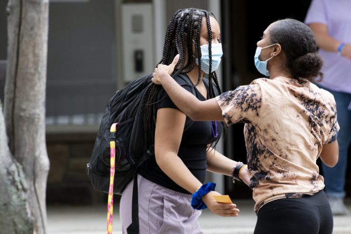 Mount Saint Mary College students move into their dorms on Sunday, August 29, 2021. Victoria Lopez and Shay Gonzalez greet each other in front of College Courts. Photo: Lee Ferris