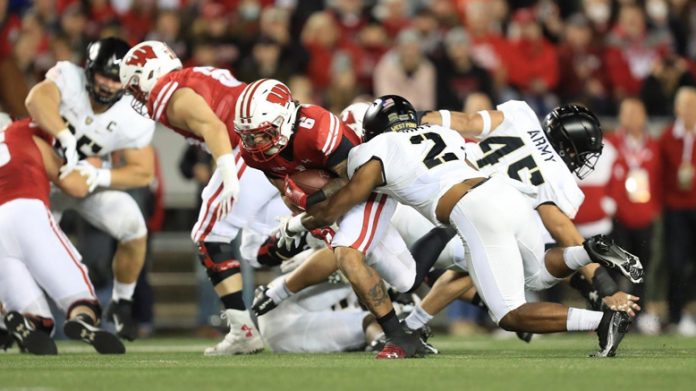 In the first-ever matchup between the Army Black Knights and Wisconsin Badgers, a crowd reaching north of 75,000 saw a wire-to-wire bout on Saturday night.