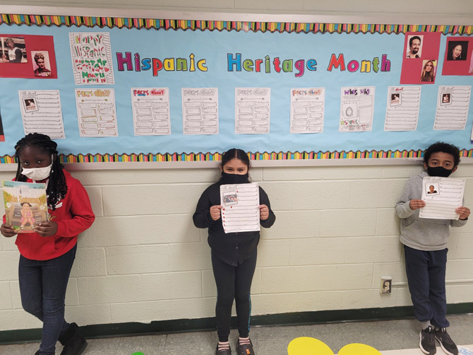 Fourth grade students in Ms. Rayford’s class display their work. The student’s work included research on famous Hispanic people and writing about them. Those stories were then placed on a decorated bulletin board in recognition of Hispanic Heritage Month. Photo: Waleska Rayford