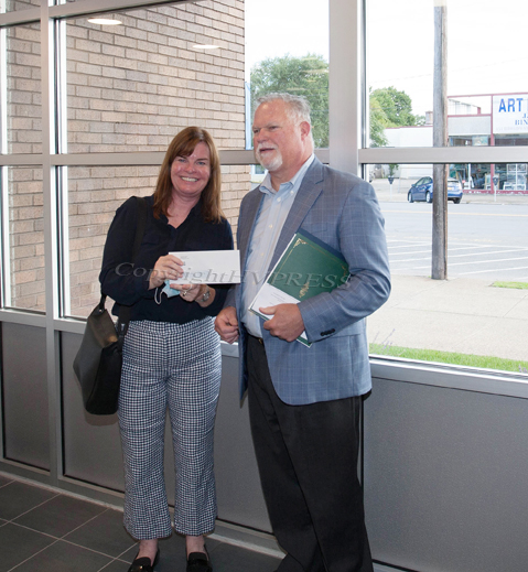 Lisa Silverstone, Executive Director of Safe Harbors of the Hudson receives a check from Rhinebeck Bank President and CEO Michael J. Quinn during the grand opening of the Newburgh branch on Wednesday, September 29, 2021. HUDSON VALLEY PRESS/ Chuck Stewart, Jr.