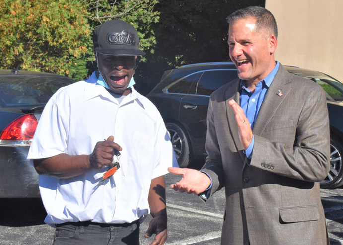 County Executive Marc Molinaro, right, presents the keys to a vehicle for a “Way to Work” recipient.
