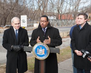 Newburgh Mayor Torrance Harvey offers remarks after NY Senator James Skoufis (D-Hudson Valley, far right) , announced $1 million in new state funding to kick off the long-awaited replacement of the dilapidated, “temporary” bridge on Lake Street in the City of Newburgh on Monday, December 20, 2021 as Assemblymember Jonatahn Jacobson and Newburgh Councilman Robert Sklarz look on. HUDSON VALLEY PRESS/ Chuck Stewart, Jr.