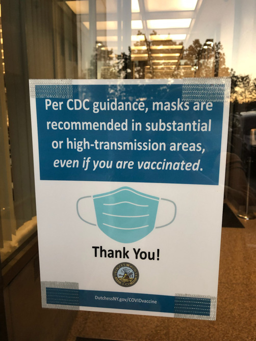 The Democratic caucus of the Dutchess County legislature called on County Executive Marcus Molinaro and County Health Commissioner Dr. Livia Santiago-Rosado to enforce the county’s COVID-safety guidance by requiring mask-wearing in the legislative chamber. Pictured above County Building with sign on door.