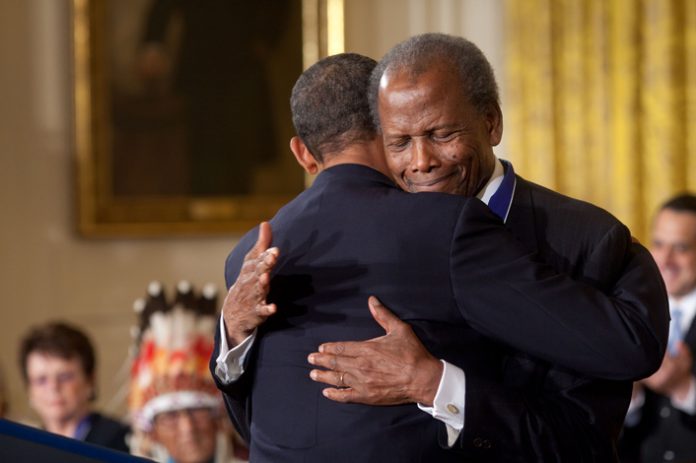 President Barack Obama hugs Presidential Medal of Freedom recipient actor Sidney Poitier during the award ceremony in the East Room of the White House, August 12, 2009. Photo: Pete Souza This official White House photograph is being made available only for publication by news organizations and/or for personal use printing by the subject(s) of the photograph. The photograph may not be manipulated in any way and may not be used in commercial or political materials, advertisements, emails, products, promotions that in any way suggests approval or endorsement of the President, the First Family, or the White House.