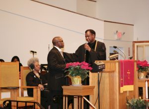 Mt. Carmel pastor Elder Thermond E. Herring presents Minister William Richardson with a Bible following his Initial Sermon on Sunday, January 9, 2011 at Mt. Carmel Church of Christ Disciples of Christ in Newburgh, NY. Hudson Valley Press File/CHUCK STEWART, JR.