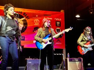 Simi Stone, Kate Pierson, and Debra Devi collaborated in a tribute to Ronnie Spector, singing the Ronettes 1963 song “Be My Baby.”