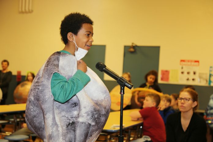 Riccardi Grade 2 student Jaylen Fletcher shares his factoids with the audience while dressed as the moon during the school’s Planet Runway event.