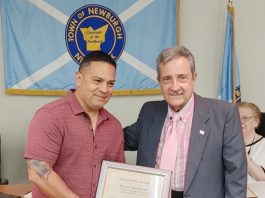 Balmville School Security Officer Hector Almodovar receives a Life Saving Award from Town Supervisor Gil Piaquadio for saving a student.