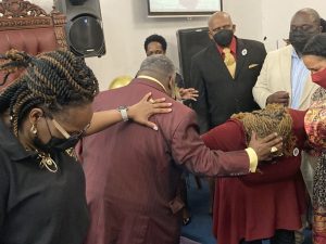 Bishop Christopher J. Hodge lays hands and prays for a church member at his 21st Pastoral Anniversary Celebration.