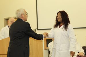 At the June 16 graduation, Surgical Technology student Daineshia Staples of Newburgh accepts her diploma from Ulster BOCES Superintendent Dr. Charles V. Khoury.