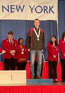 Ulster BOCES Heating, Ventilation & Air Conditioning student Eric Oakley, from the Rondout Central School District, receives his medal at the 2022 SkillsUSA State Conference for placing third in the Hydronic Heating category.