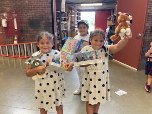 Some of the many children who attended last Monday’s First Annual Summer Toy Giveaway at the Newburgh Armory Unity Center show off their selected treasures.