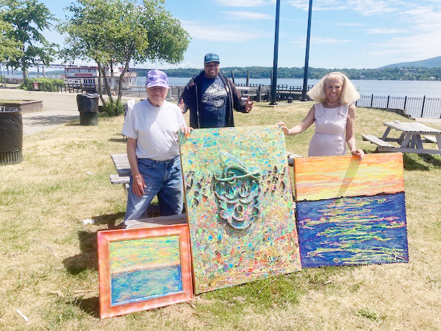 Town of Newburgh residents, Frank Scarzfava, left, and Mary Balduc, right, stand alongside City of Newburgh artist Eddison A. Romeo, center, and some of his three dimensional artwork at the Newburgh Waterfront last week.