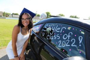 Saugerties senior Skyler Catalano poses for a quick photo in front of her decorated car moments before the start of graduation.