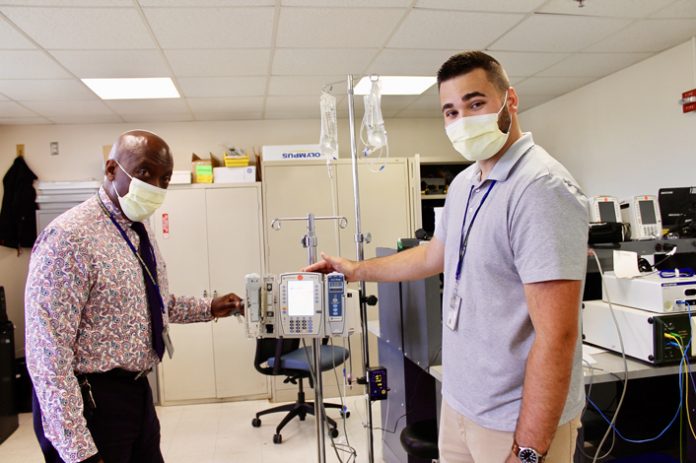 Chief Biomedical Engineer Gregory Johnson (left) and Biomedical Information Specialist Nick Martorano (right), check a piece of equipment at the Castle Point VA Medical Center. Morano is a 2014 graduate of the Highland Central School District and the Ulster BOCES Cisco & Cybersecurity program at the Career & Technical Center, where he says his instructors encouraged him to take on challenges and pursue a successful career.