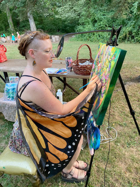 Local artist, Hilary Astrid, works on her floral painting during last Saturday’s opening day of the week-long “Butterflies and Blooms” festival, held at Fishkill’s Stony Kill Farms Environmental Center.