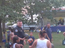 An officer is interacting with a family through the game of basketball during Middletown Police Department’s local National Night Out.