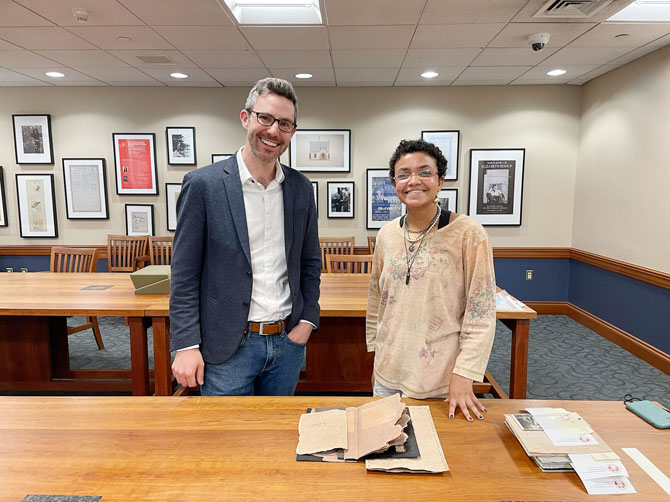 John Murphy, the Loeb’s curator of prints and drawings, and Ford Scholar Carissa Kolcun pose with 11033, an artist’s book that chronicles the story of Mary Morst, who gave birth to twins while she was incarcerated in a Virginia prison in 1913. Photo: Betsy Subiros ’25
