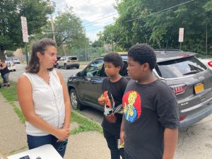 Mary kate Lowe, Executive Director of Big Brothers Big Sisters of Orange County, chats with from left, Jaden Page and Zachary Mitchell about her organization at Thursday’s Team Newburgh community outreach event.