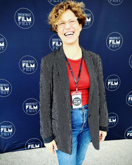 Nela Wagman, one of the film makers poses for a photo in front of the Hudson Valley Film Festival media backdrop.